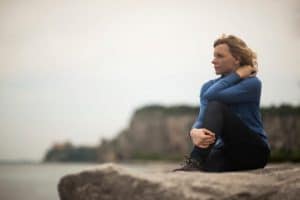 woman sitting on rock benefits from substance abuse treatment