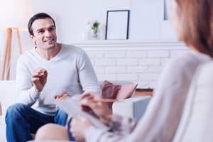 man talks to therapist about inpatient rehab