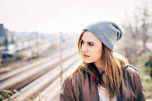 woman standing by the train tracks considers beginning Alcohol Detox