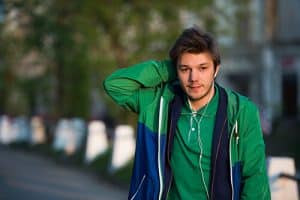young adult male in green hoodie has marijuana addiction