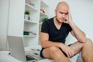 man sitting by laptop goes through xanax withdrawal