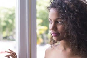 woman looking out window needs drug addiction recovery