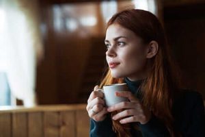 woman drinking coffee thinking about her recovery options