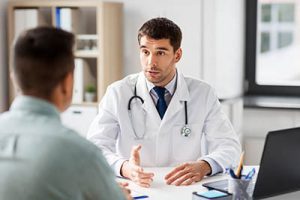 doctor explains to patient how pcp addiction rehab can help him