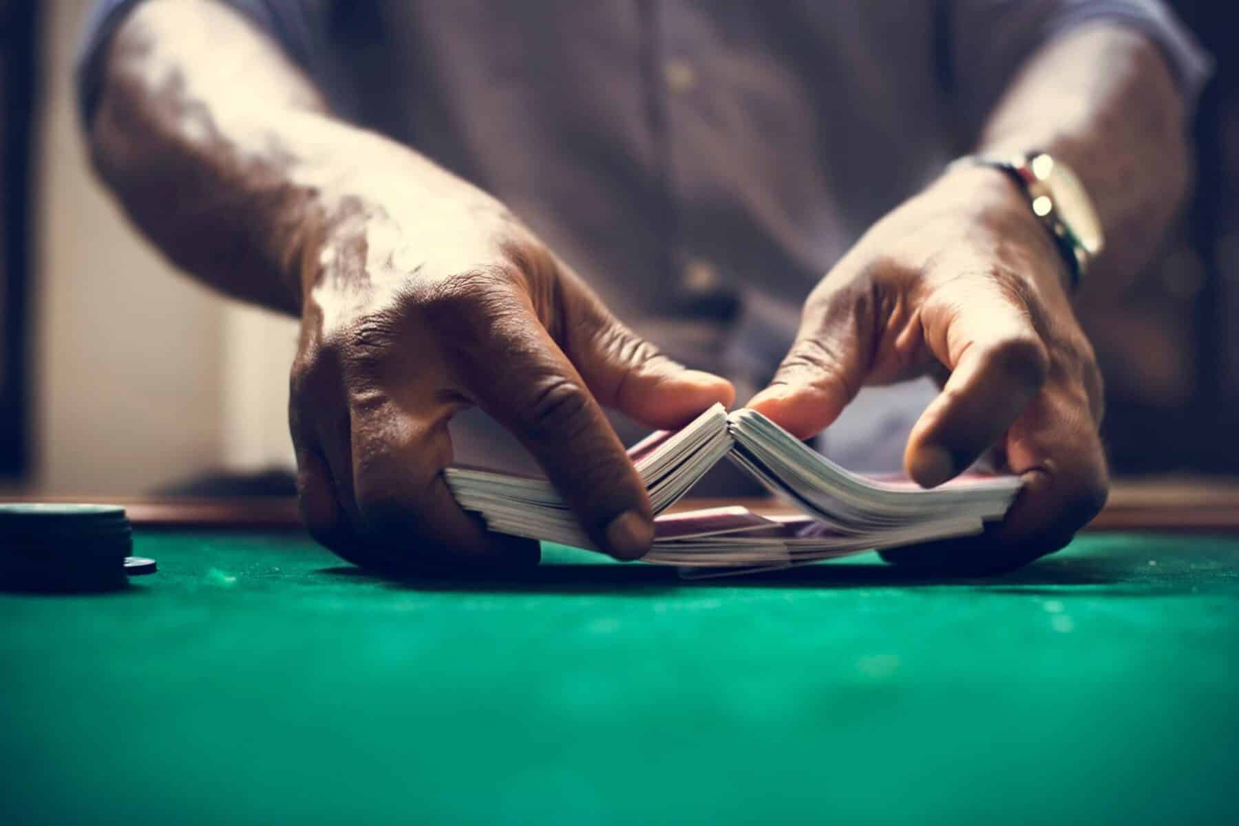 A man gambling and shuffling cards