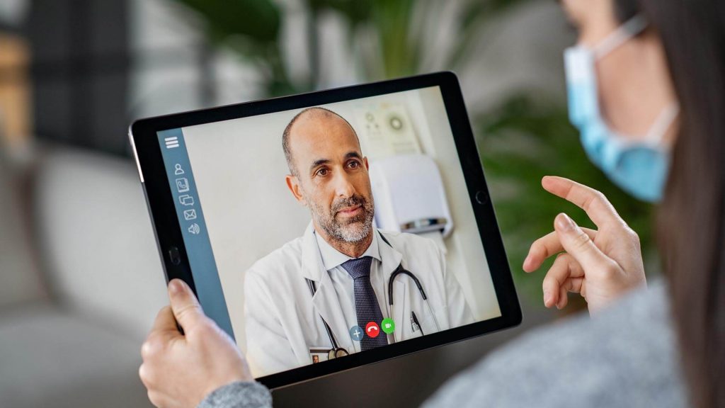 doctor talking to patient through telehealth