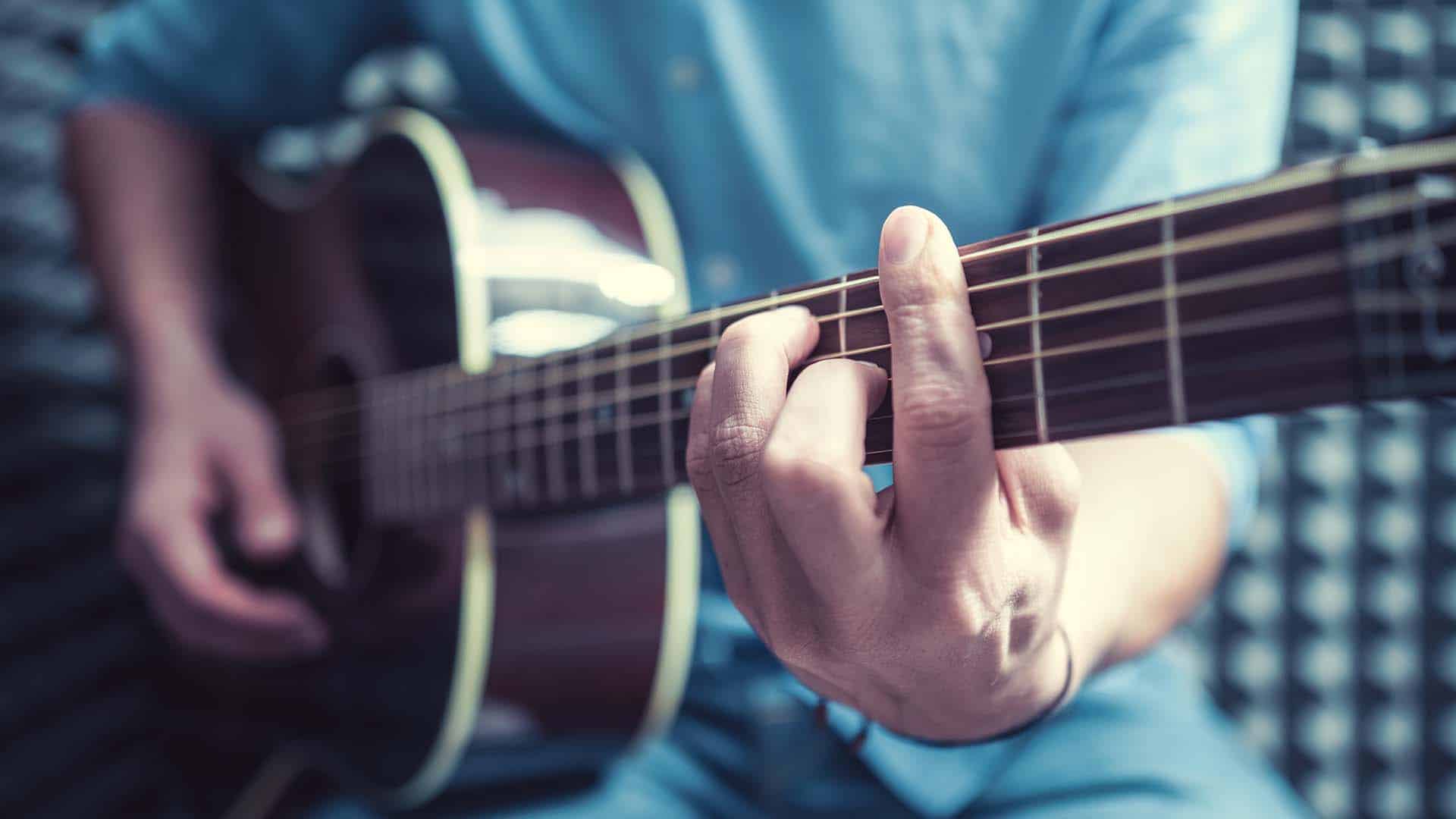 Man playing guitar indoors