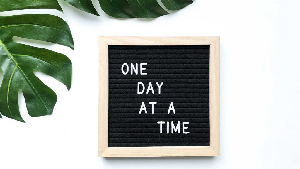image of a sign that says one day at a time