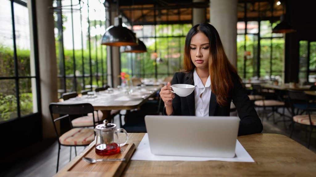 Portrait of young beautiful Asian businesswoman working at the coffee shop