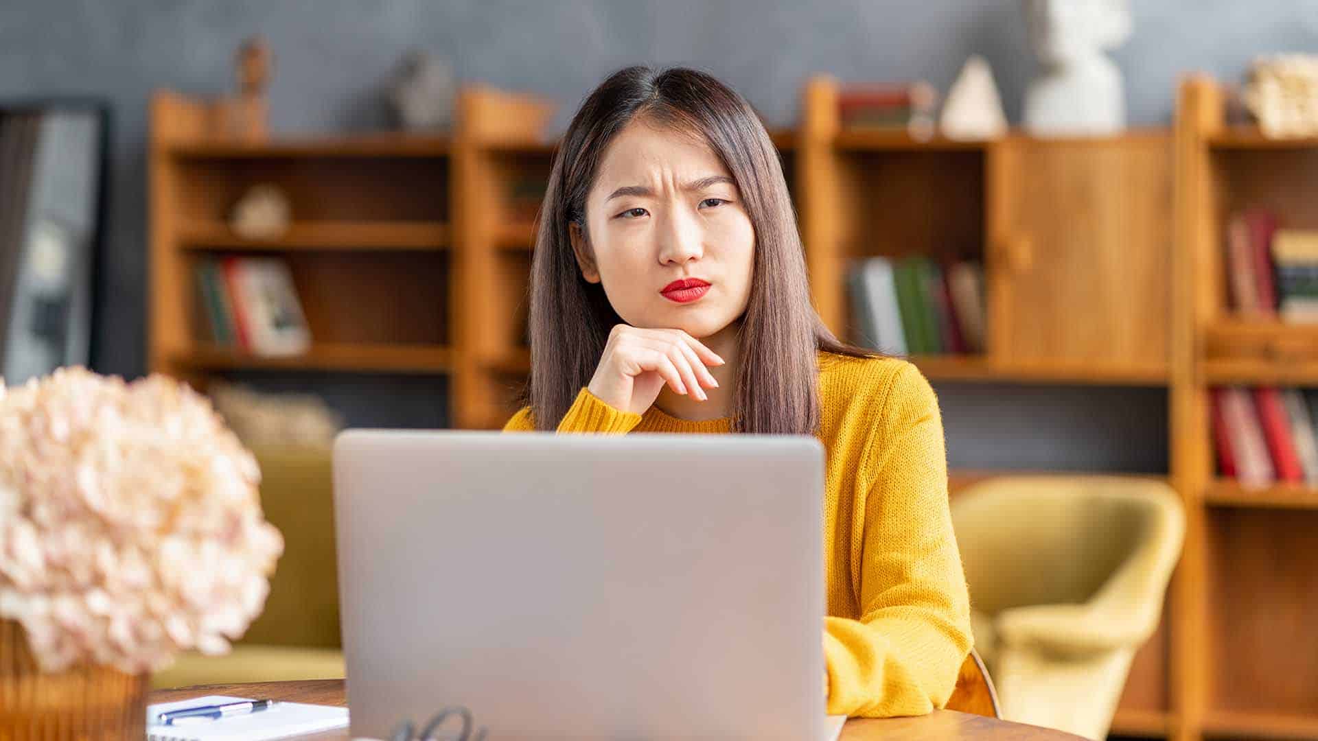 woman frowning at her computer